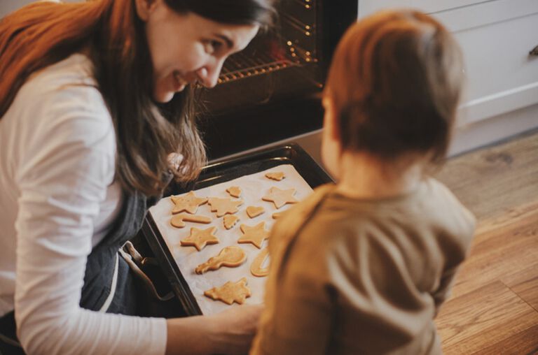 A mom and her son baking cookies.