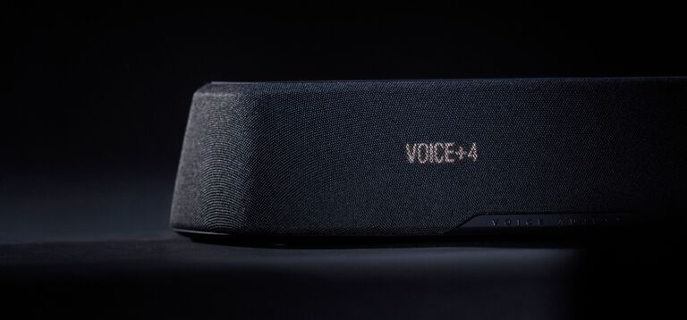 Woman watching tv with a compact sound bar.