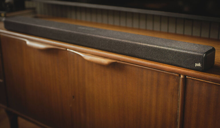 Soundbar sitting on a dresser.