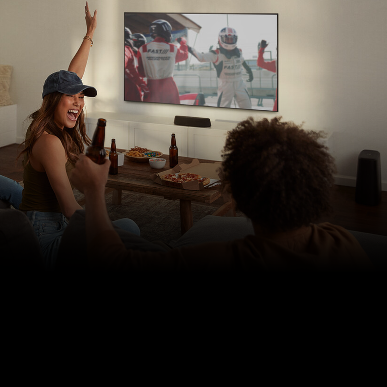 Woman excited watching sports on tv