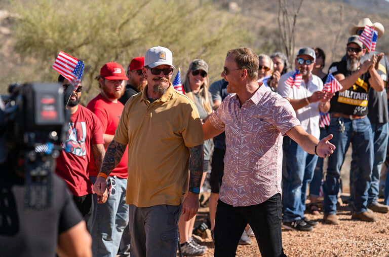 A crowd of people cheering for a house reveal