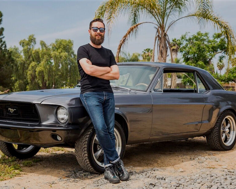Guy leaning against a car