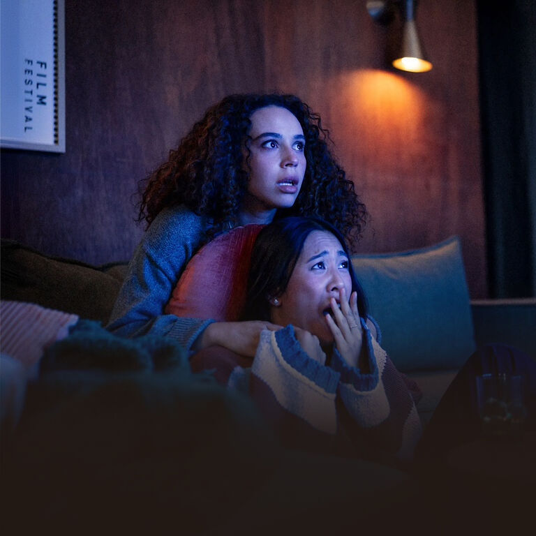 Two girls watching a scary movie