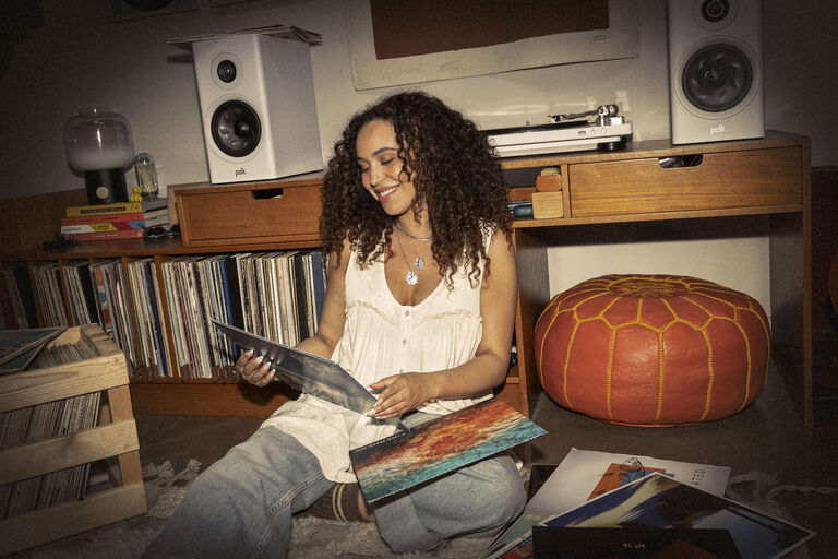 Girl sitting on a floor looking at albums
